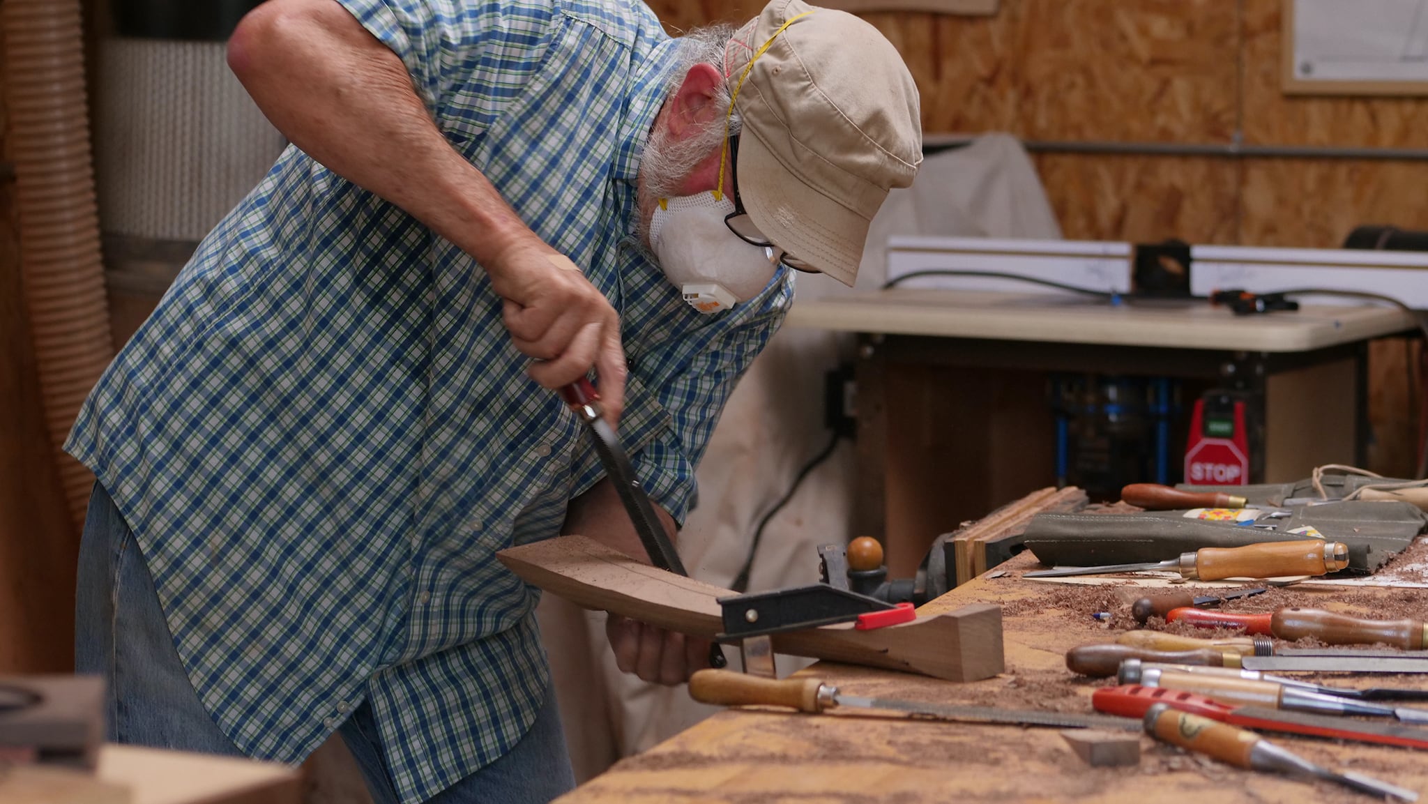 Shaping a black walnut chair arm with a Shinto rasp at Sam Maloof woodworking foundation in Alta Loma, California