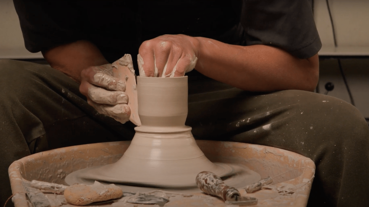 Throwing clay off the hump