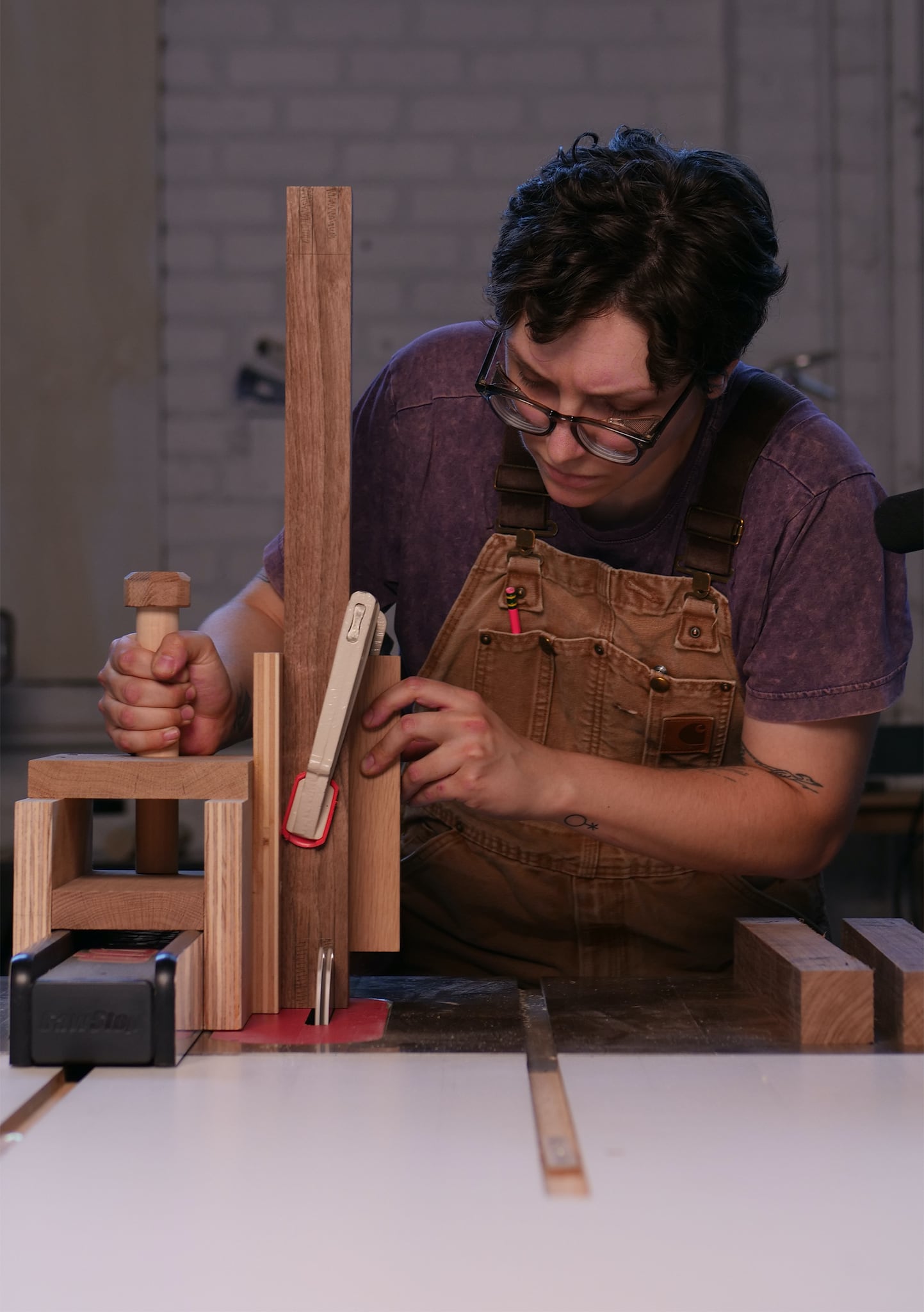 Lauren Verdugo pushing walnut wood stock through a table saw at Allied Woodshop in Los Angeles, California.